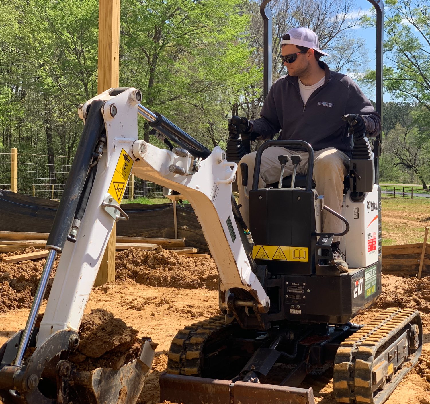 Crockett Ford drives an excavator at a new home site in Canton.
